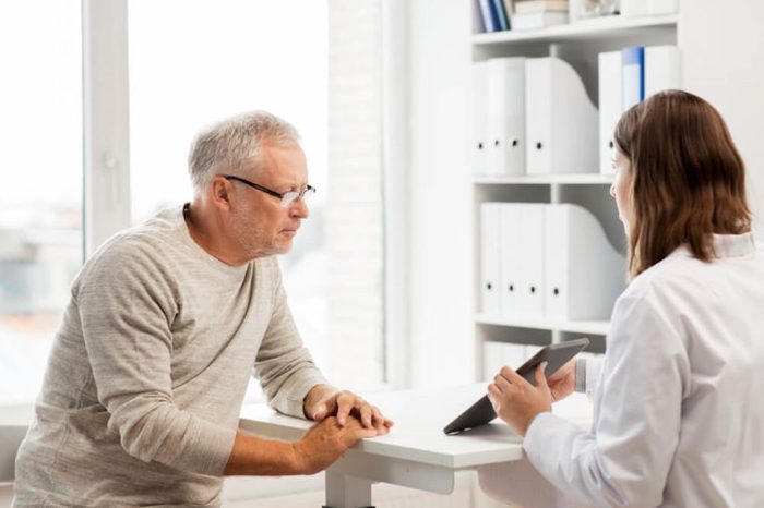 man patient speaking with a woman doctor