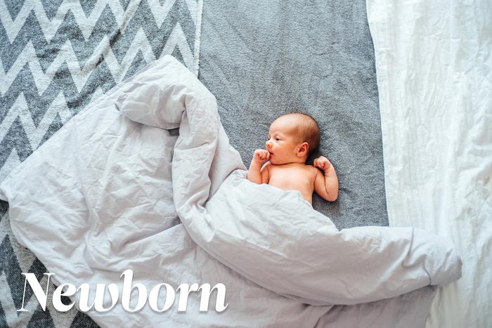 newborn baby with a comforter