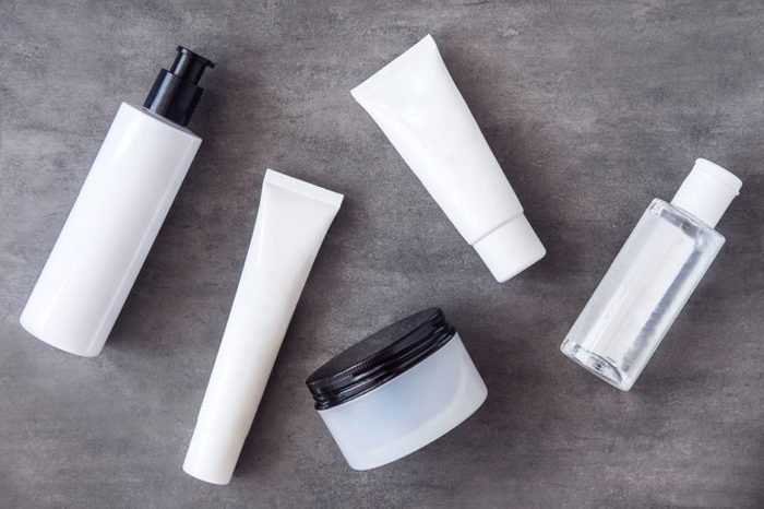 Bottles, tubes and jars with natural skincare beauty products from above.