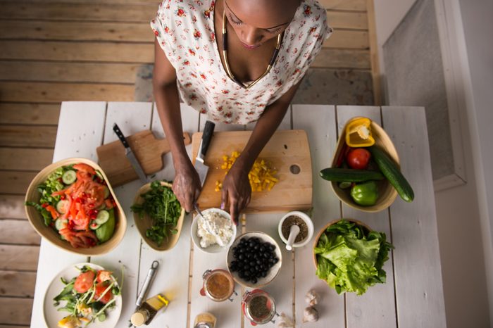woman preparing meal with healthy food
