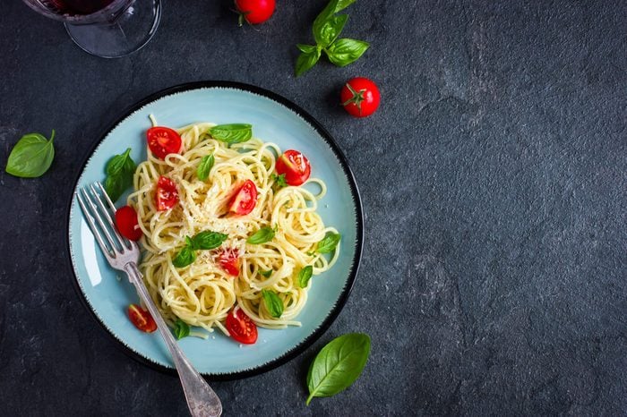 Spaghetti pasta with cherry tomatoes, basil and parmesan cheese