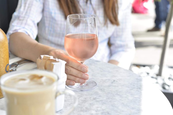 Woman's hand holding a glass of rose wine