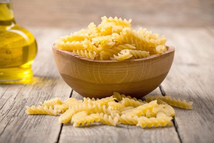 Italian pasta in wooden bowl