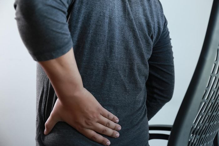 young man Feeling suffering Lower back pain Pain relief concept