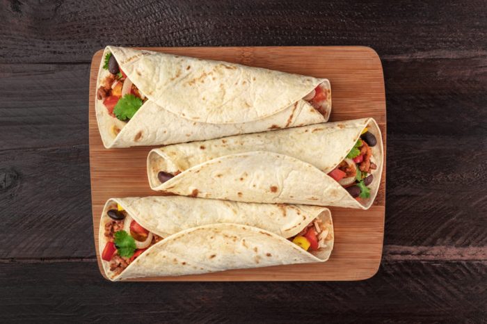 Mexican burritos on a wooden slab