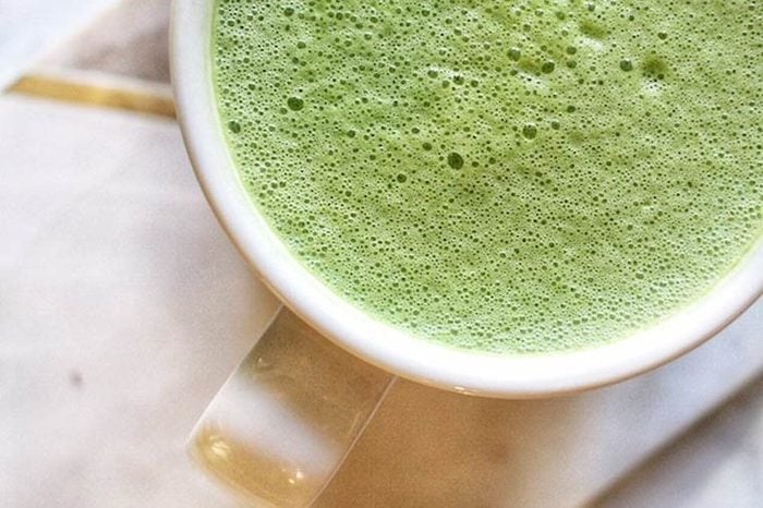 green matcha drink in white coffee cup