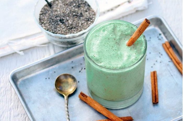 thick green smoothie with cinnamon sticks