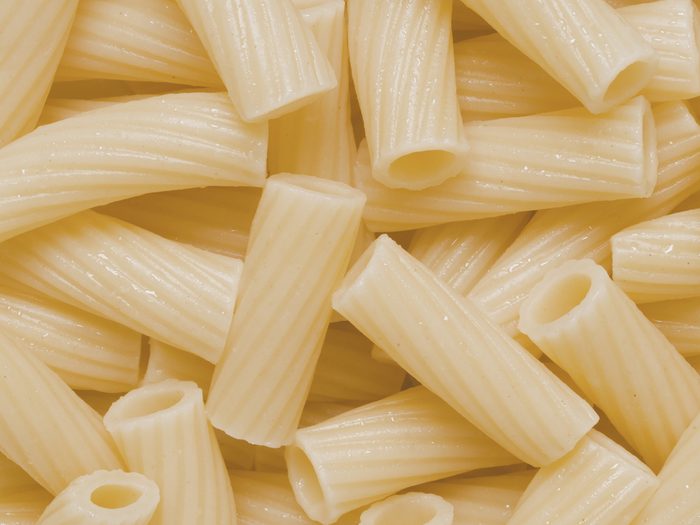 close up of cooked maccheroni pasta tubes food texture background
