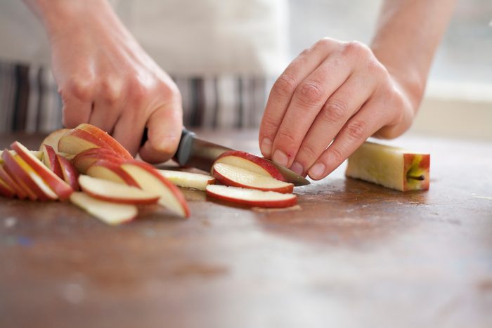 close up of woman slicing apples