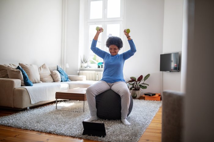 woman doing an online workout at home
