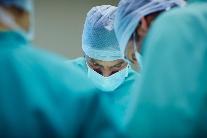 surgeons working in operating room in hospital