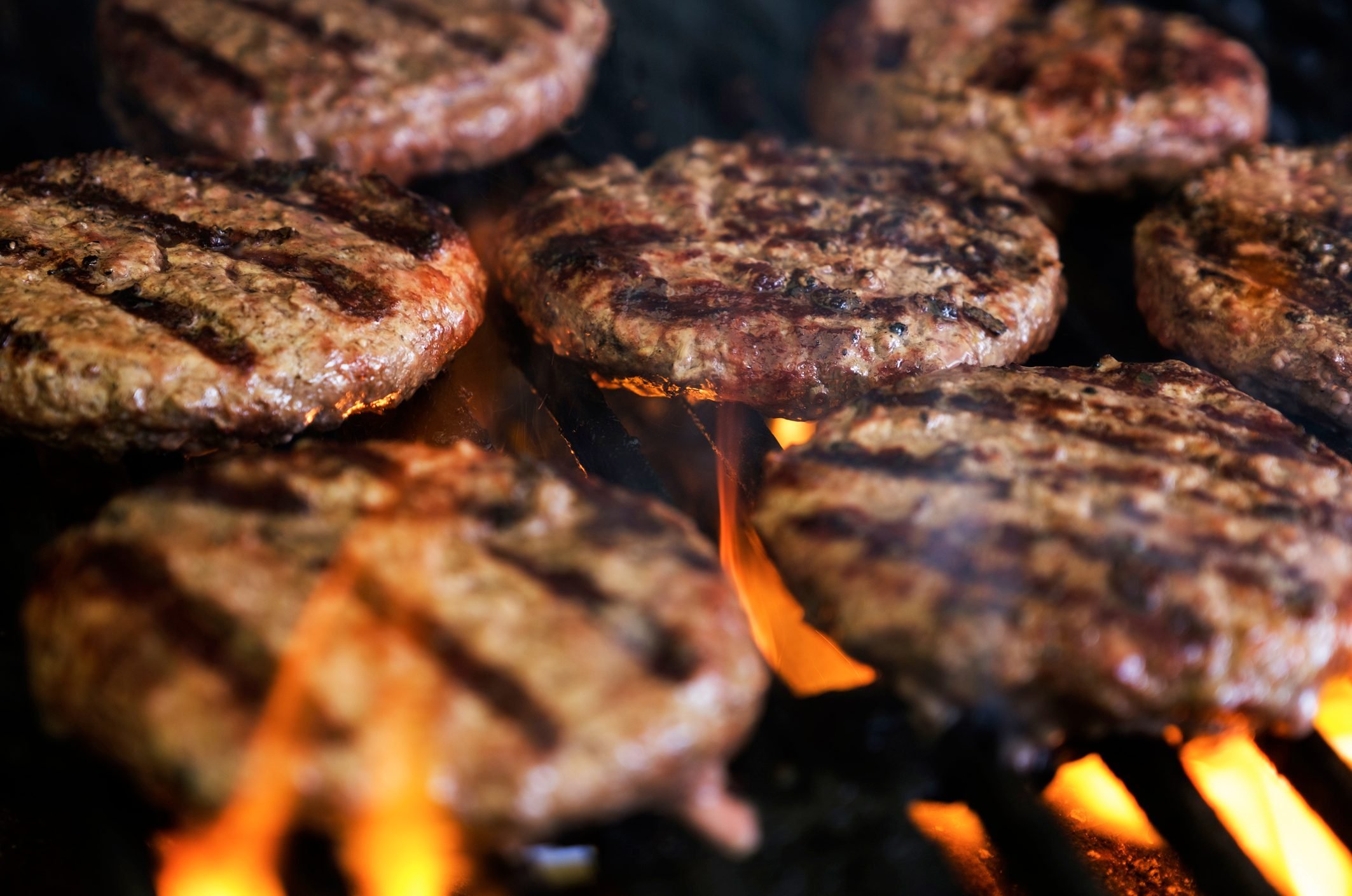 close up of burger patties on the grill