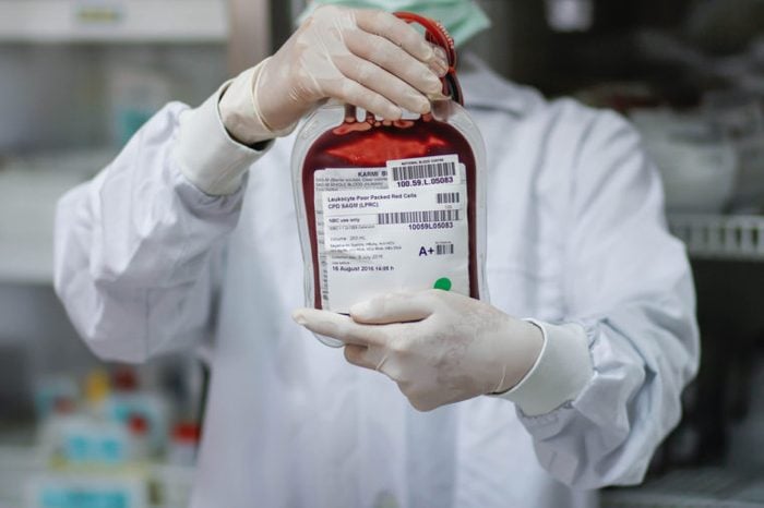 Doctor holding fresh donor blood for transfusion.