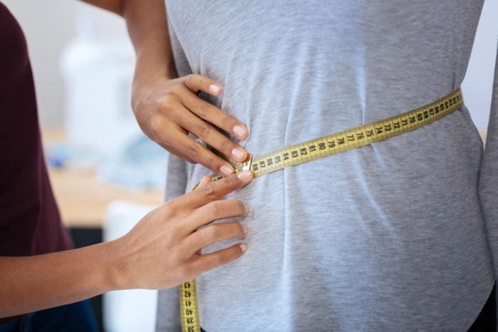 Measuring waist with a tape measure