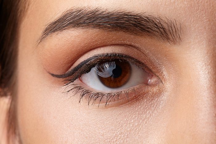 Woman with a brown eye wearing eyeliner and mascara.