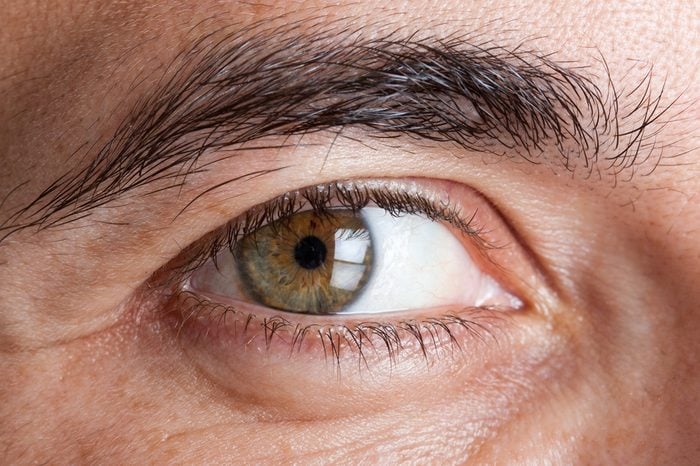 Closeup image of a man's green eye