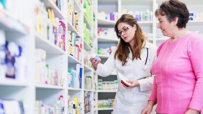 pharmacist looking at label with patient