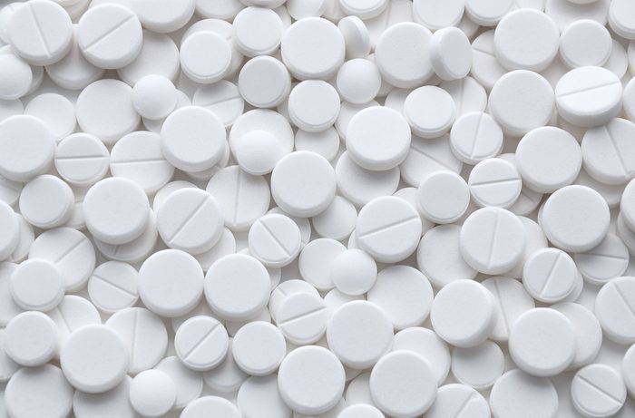 White pills (tablets) background. Medicine objects.