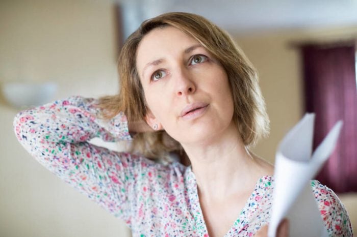 Mature Woman Experiencing Hot Flush From Menopause