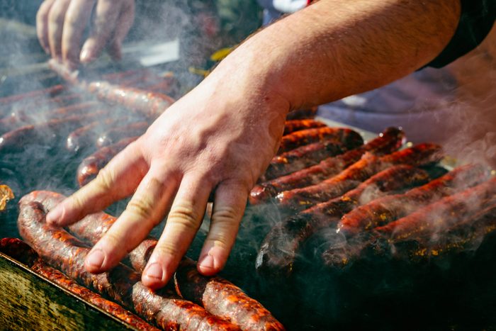 hand on grill meat