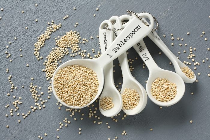 Quinoa grain in porcelain measuring spoons