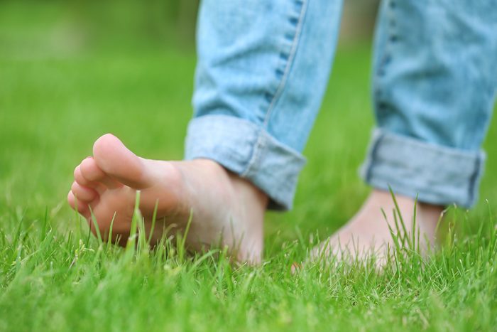 walking barefoot on green grass