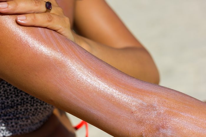 woman spreading on sunscreen