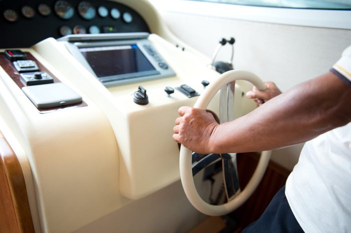 person steering a yacht