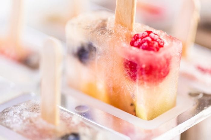 Homemade fresh fruit popsicles with raspberries and blueberries