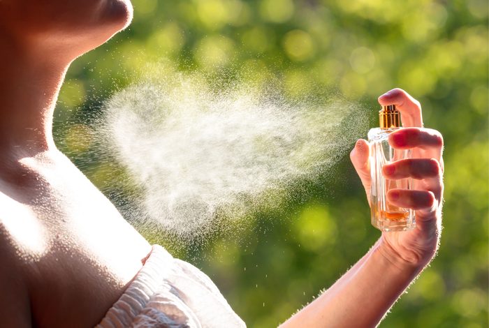 woman spraying perfume