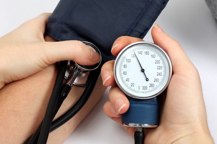 Doctor measuring blood pressure of a patient.