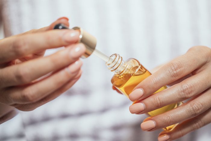 woman's hands holding skin oil