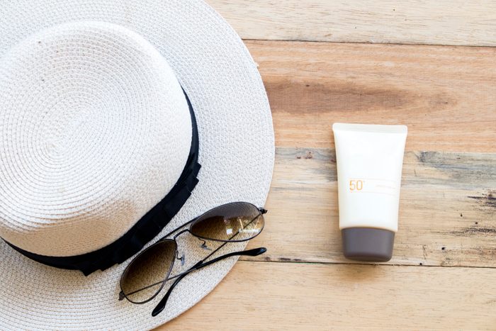 straw hat, sunscreen, and sunglasses
