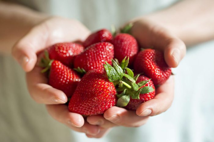 Man hands holding fresh strawberries