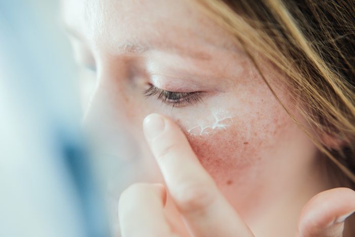 close up of woman applying face cream