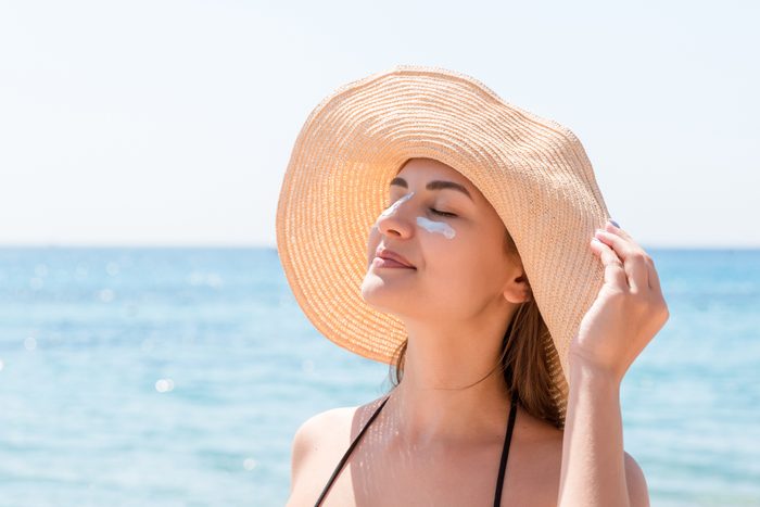 woman in sun hat at the beach