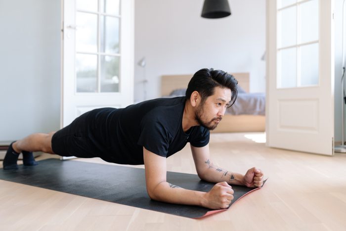 man in plank position exercising at home