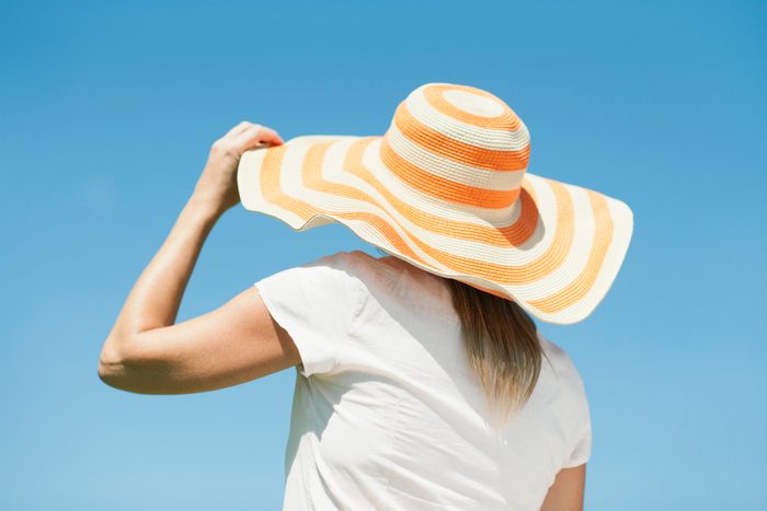 rear view of woman wearing sun hat