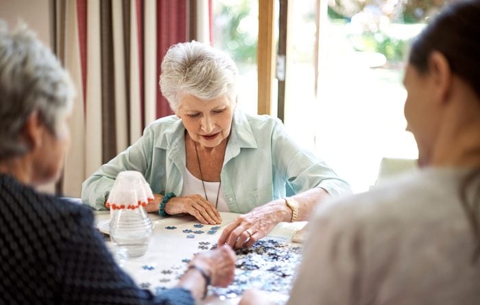 group of senior women working on a puzzle