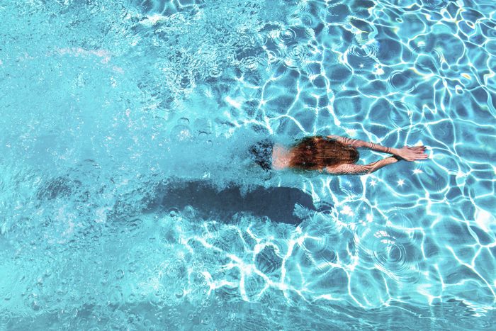 overhead shot of woman swimming in pool
