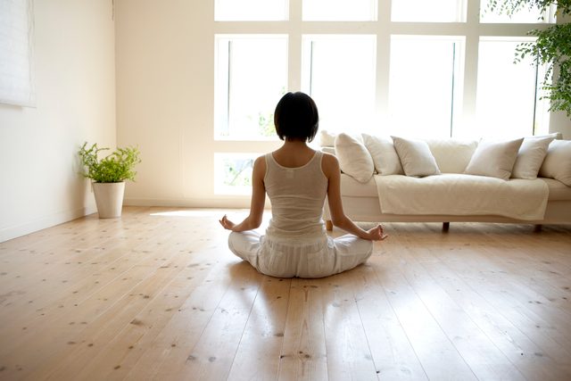 young woman meditating at home