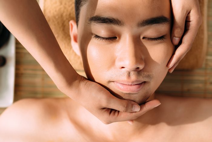 Close-up of man enjoying professional facial massage