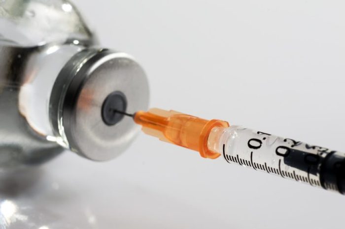 macro photography of a syringe ready to put a vaccine