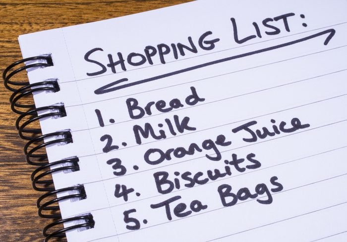 A shopping list written in a notepad.