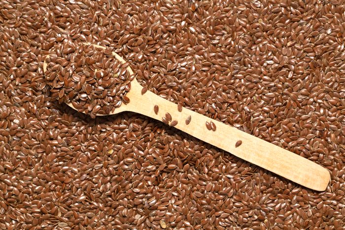 Brown flax seeds. Close up of grains, flax seeds background. Flat lay, top view.