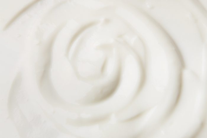 Sour cream texture background, top view