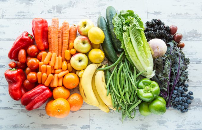 Variety of fresh fruits and vegetables sorted by colors