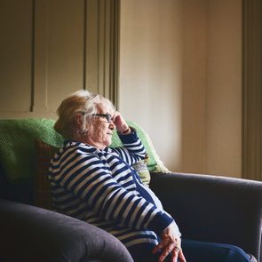 senior woman sitting at home alone