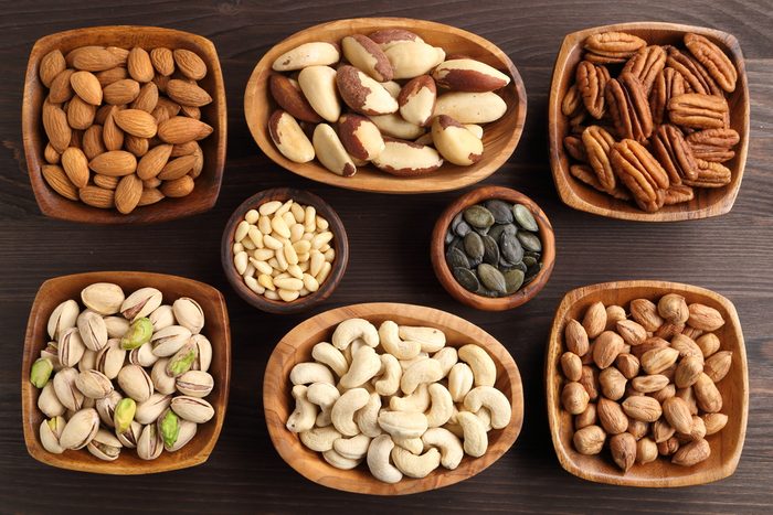 Different kinds of nuts in wooden bowls.