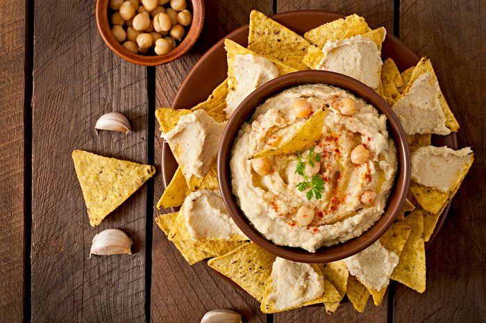 Healthy homemade hummus with olive oil and pita chips